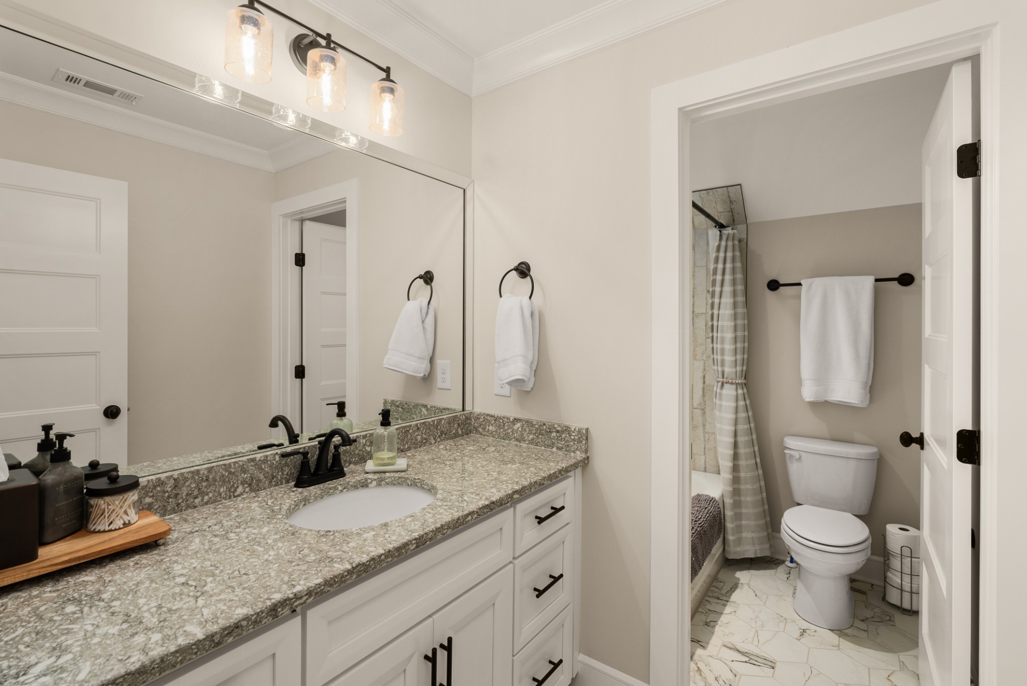 1497 Phillips Road Lebanon, TN 37087 - Photo 33 of 53 a bathroom with a granite countertop sink a toilet and a mirror