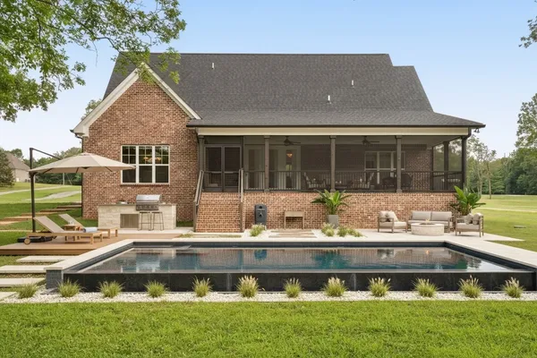 a front view of a house with a garden