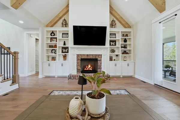 a kitchen with stainless steel appliances a kitchen island a stove a table and chairs in it