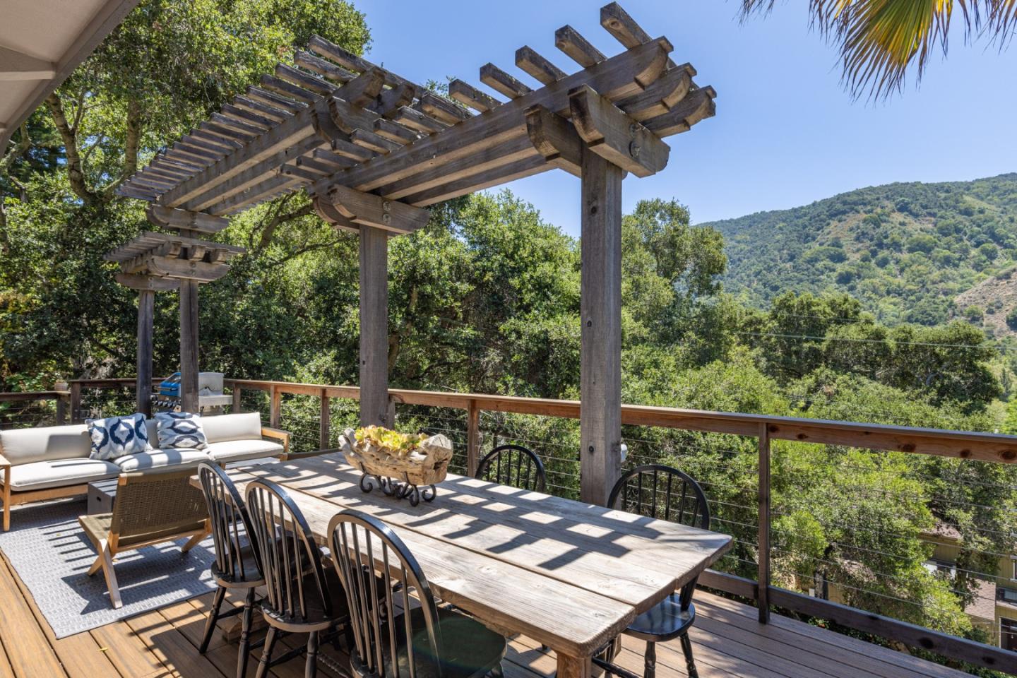 55 Paso Cresta Carmel Valley, CA 93924 - Photo 12 of 31 a view of a dinning table and chairs in the balcony