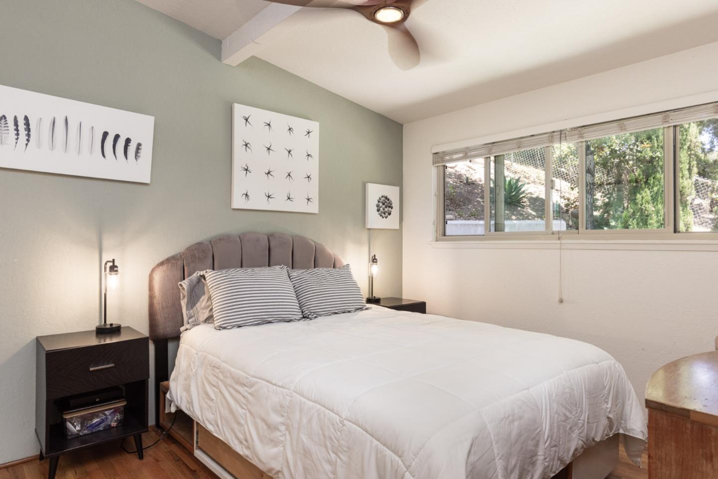 55 Paso Cresta Carmel Valley, CA 93924 - Photo 14 of 31 a bedroom with a large bed and a lamp on dresser