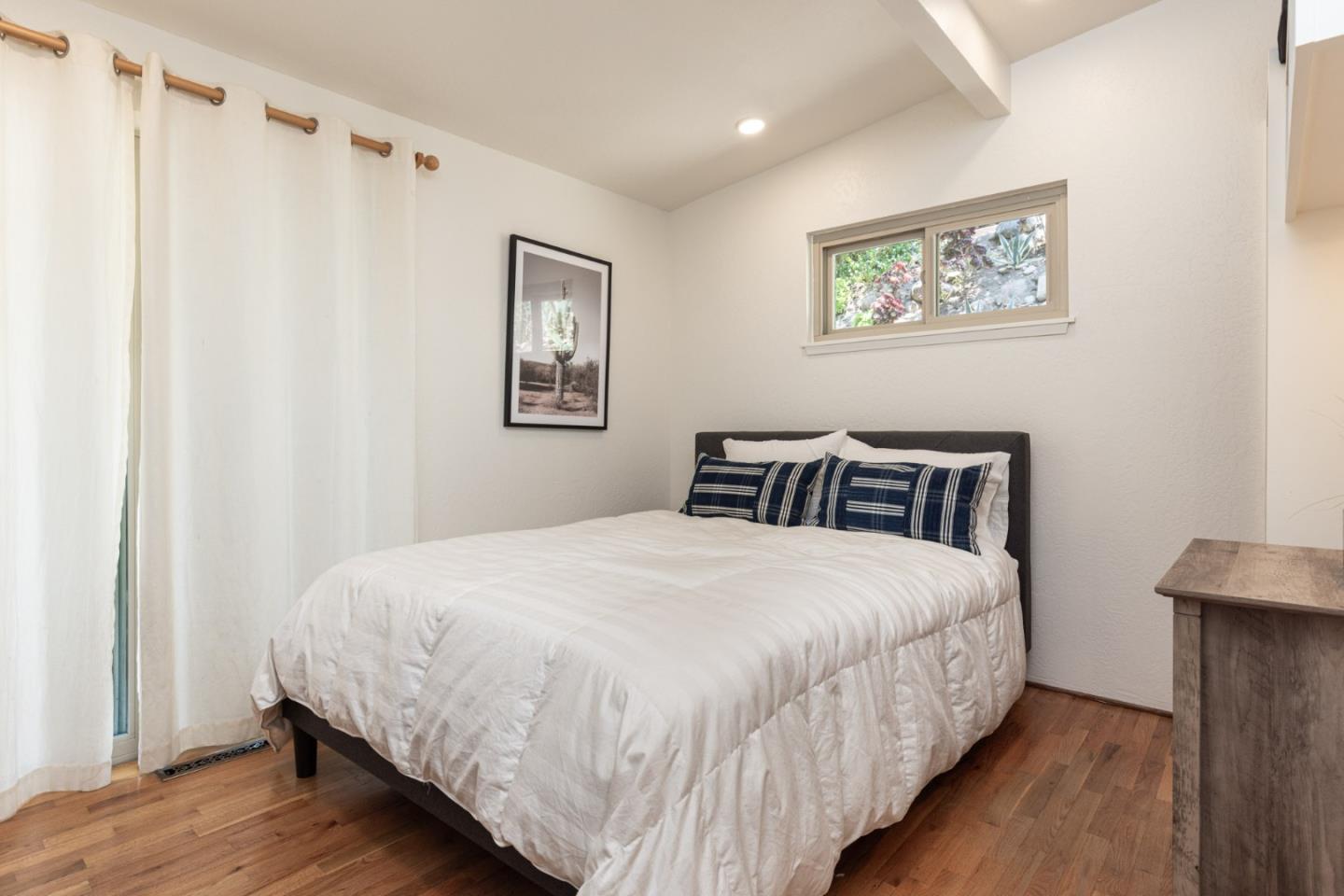 55 Paso Cresta Carmel Valley, CA 93924 - Photo 16 of 31 a bedroom with bed and painting on the wall