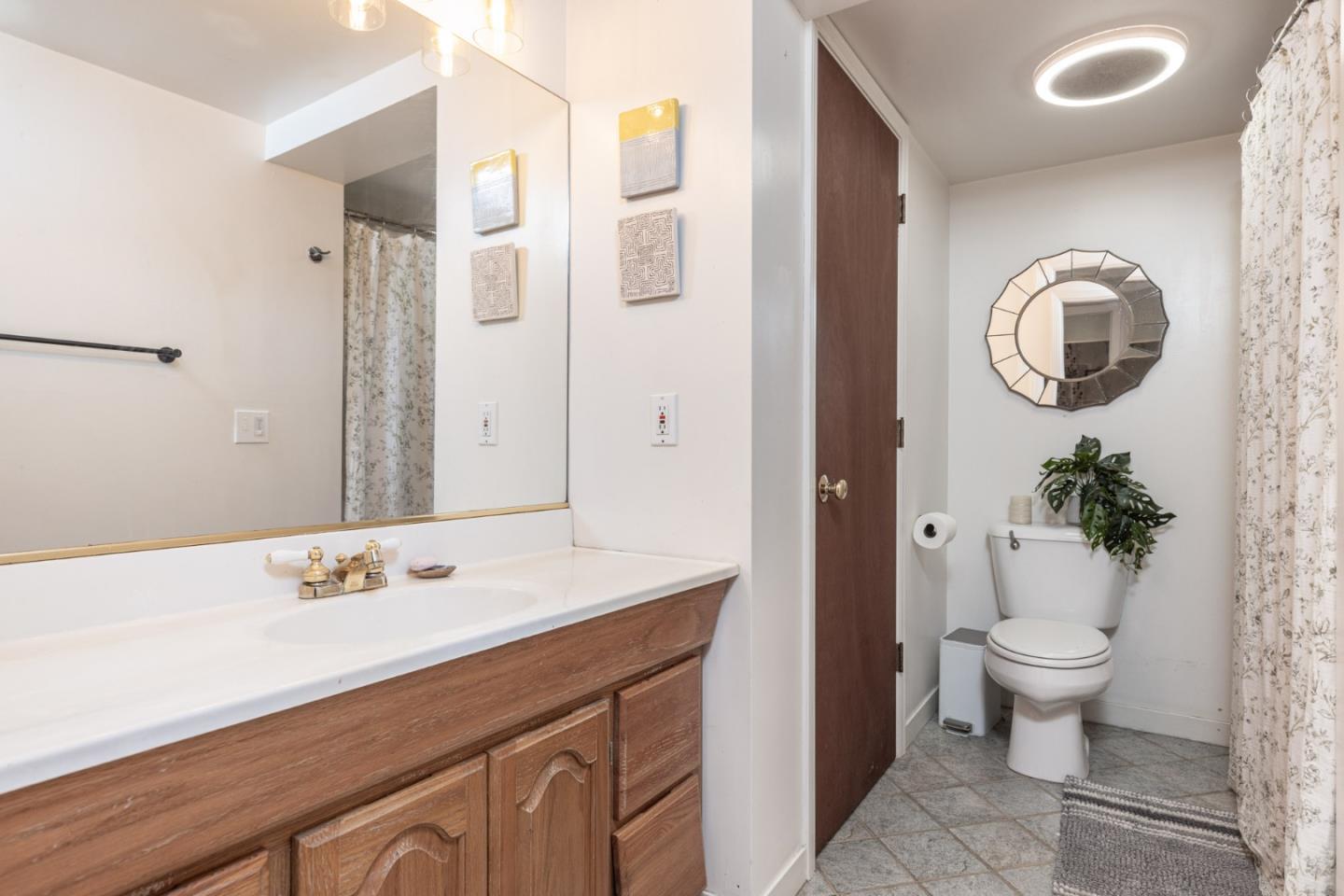 55 Paso Cresta Carmel Valley, CA 93924 - Photo 20 of 31 a bathroom with a sink a toilet and a mirror