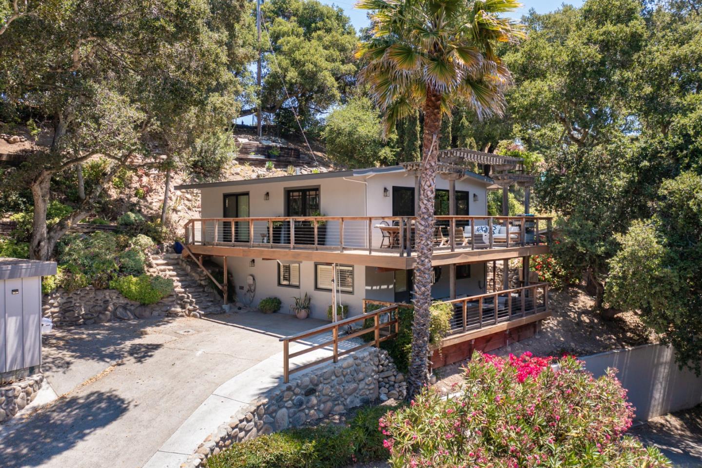 55 Paso Cresta Carmel Valley, CA 93924 - Photo 2 of 31 a view of a house with a yard and garden