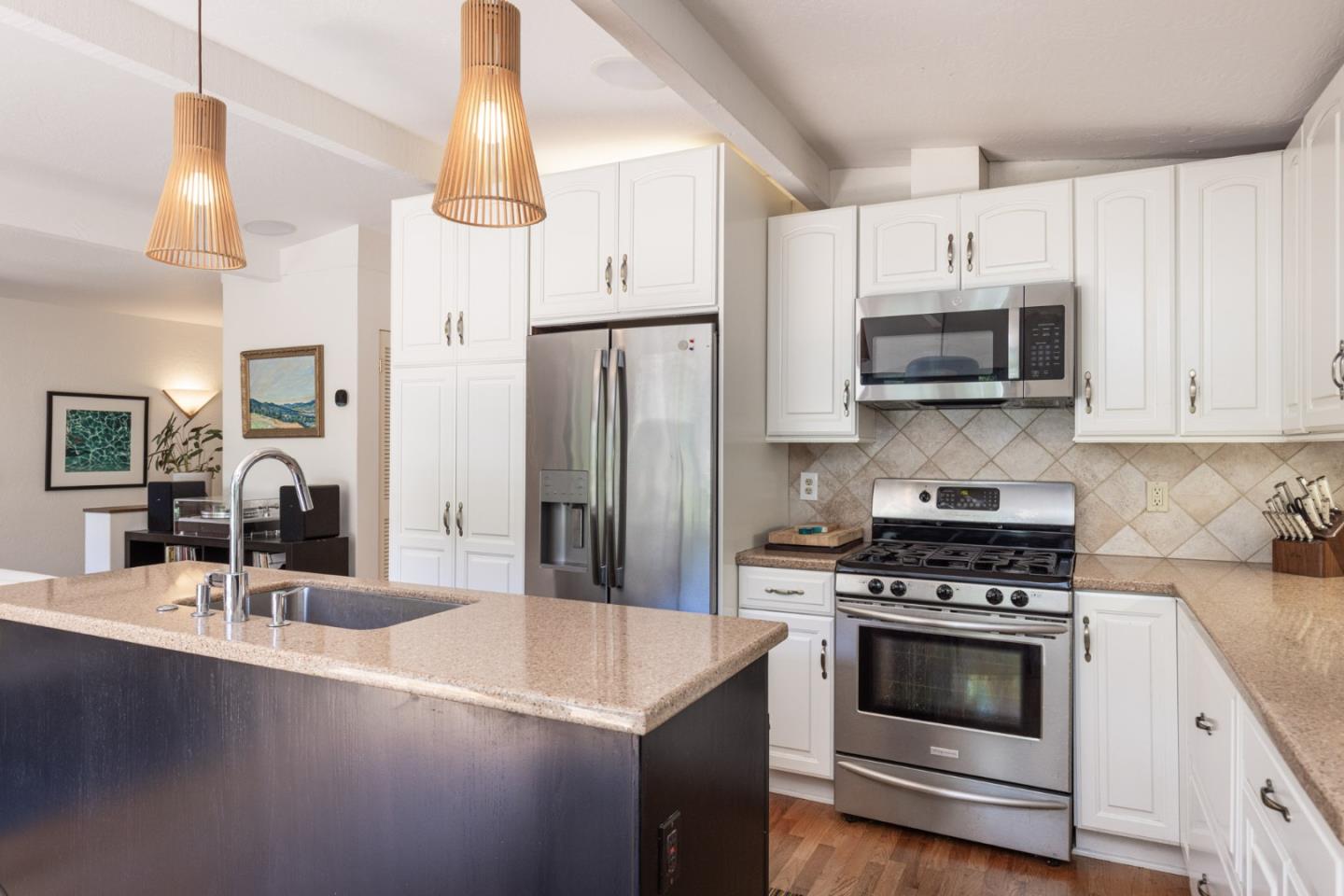 55 Paso Cresta Carmel Valley, CA 93924 - Photo 8 of 31 a kitchen with stainless steel appliances a stove a sink a microwave and cabinets