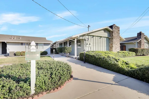 a front view of a house with a garden
