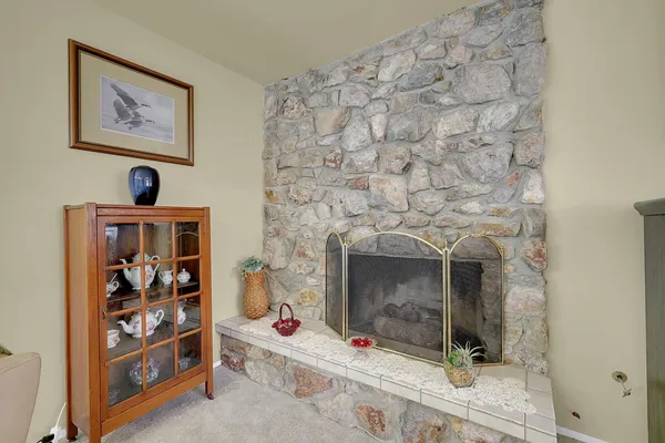 a living room with a fireplace with a bookshelf