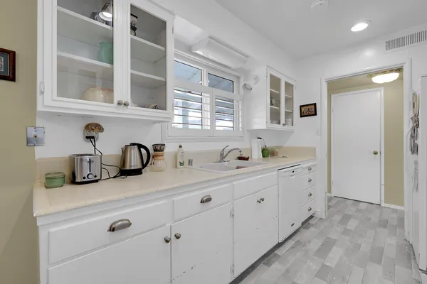a bathroom with double sink and a window