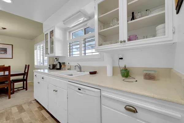 a kitchen with cabinets appliances a sink and a window