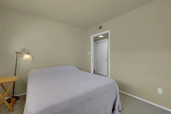 a bedroom with a bed and a desk