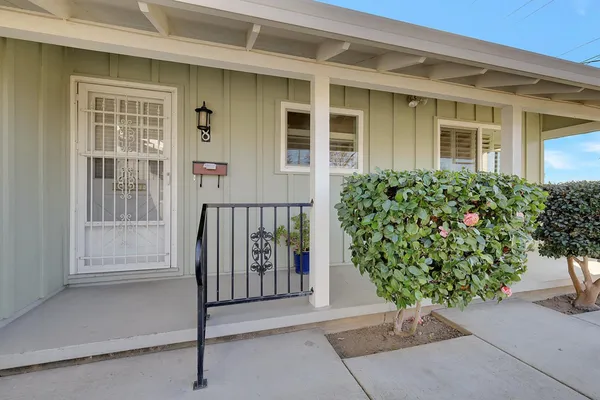 front view of a house with a potted plant
