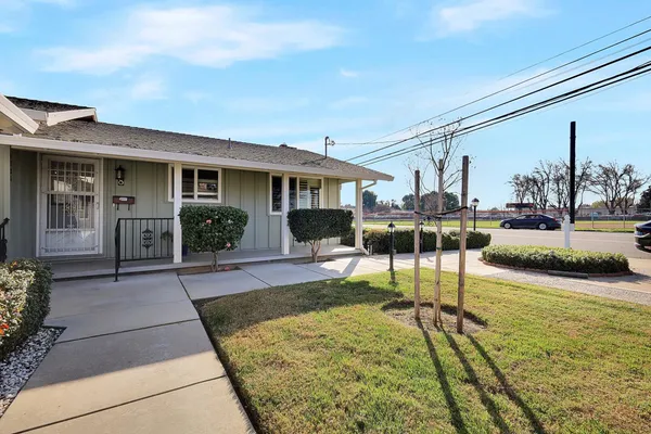 a view of a house with backyard patio and swimming pool