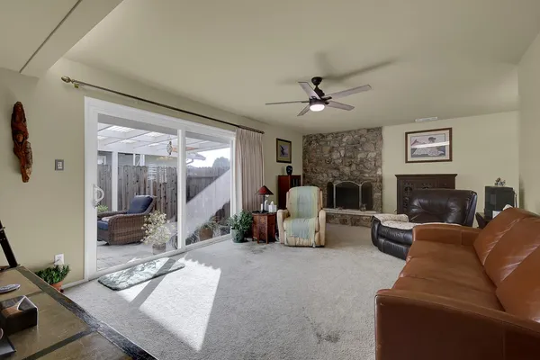 a living room with furniture a large window and a fireplace