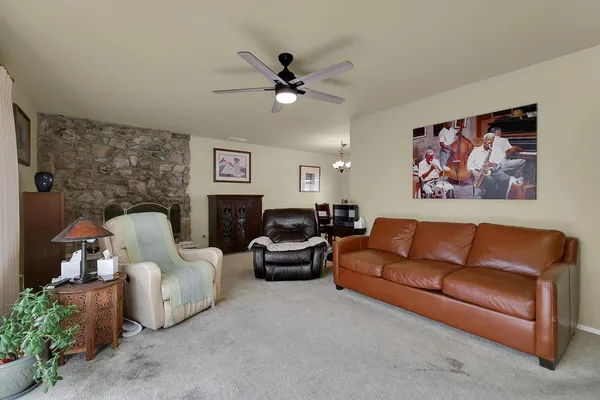 a living room with furniture and a chandelier