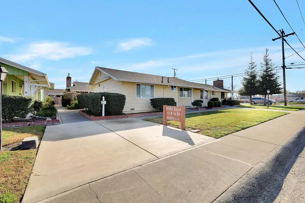 a view of a house with swimming pool and a yard