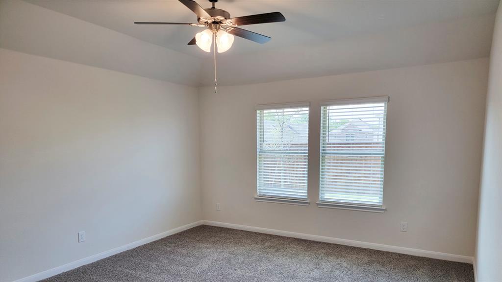 1807 Teton River Drive Blue Ridge, TX 75424 - Photo 2 of 12 an empty room with a window and a fan