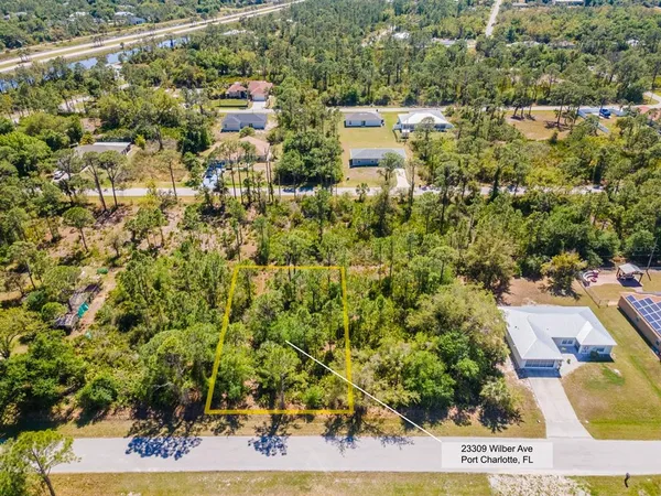 an aerial view of a house with a yard
