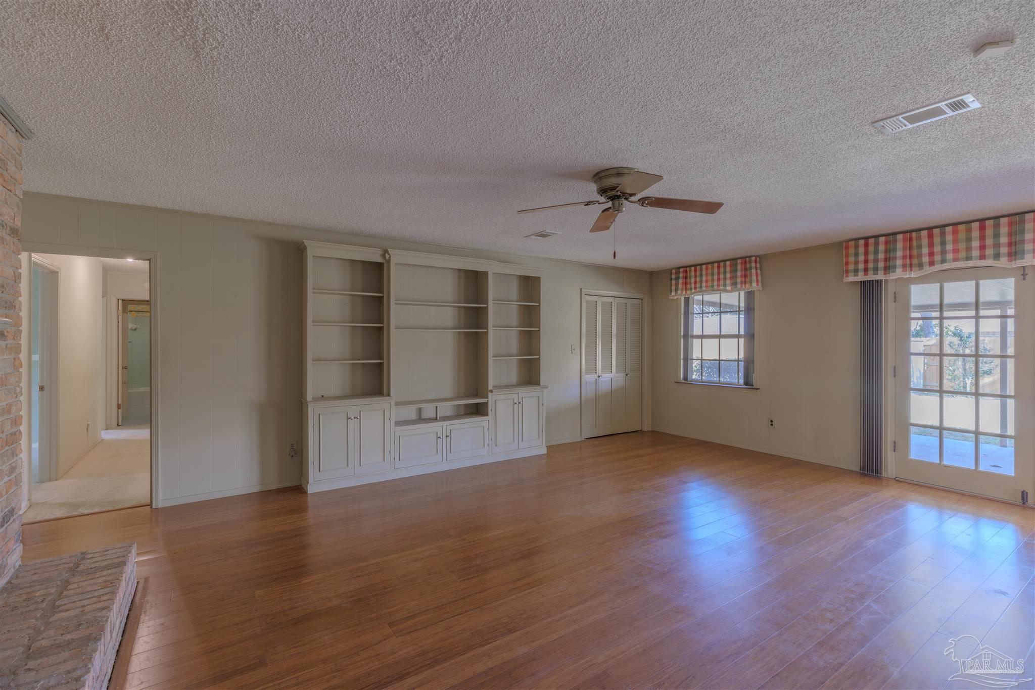 5700 Adelyn Road Pensacola, FL 32504 - Photo 13 of 33 a view of an empty room with a window and wooden floor