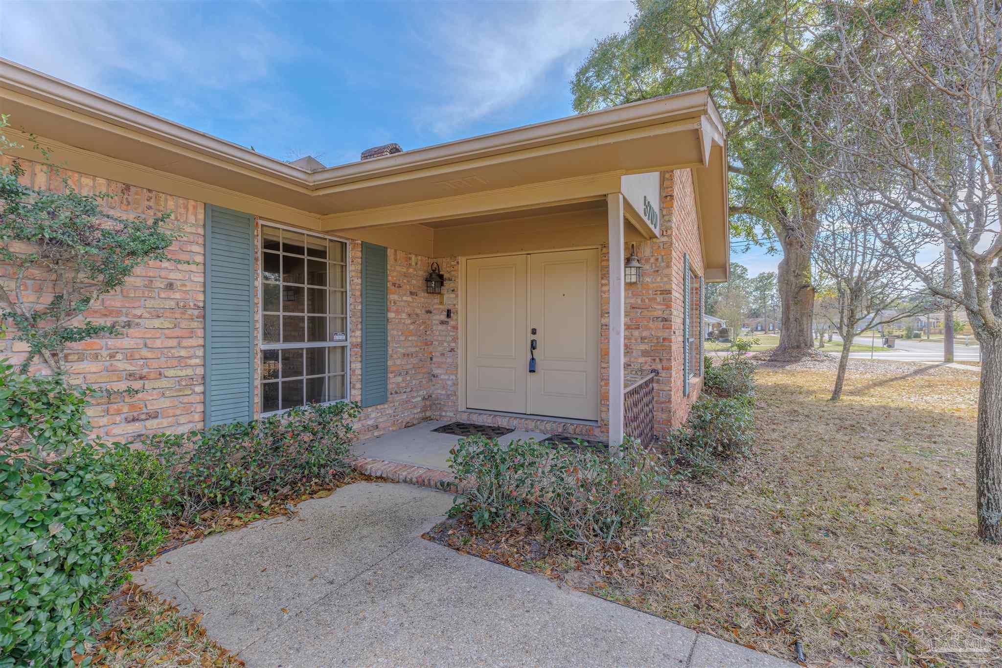 5700 Adelyn Road Pensacola, FL 32504 - Photo 2 of 33 front view of a house with a yard