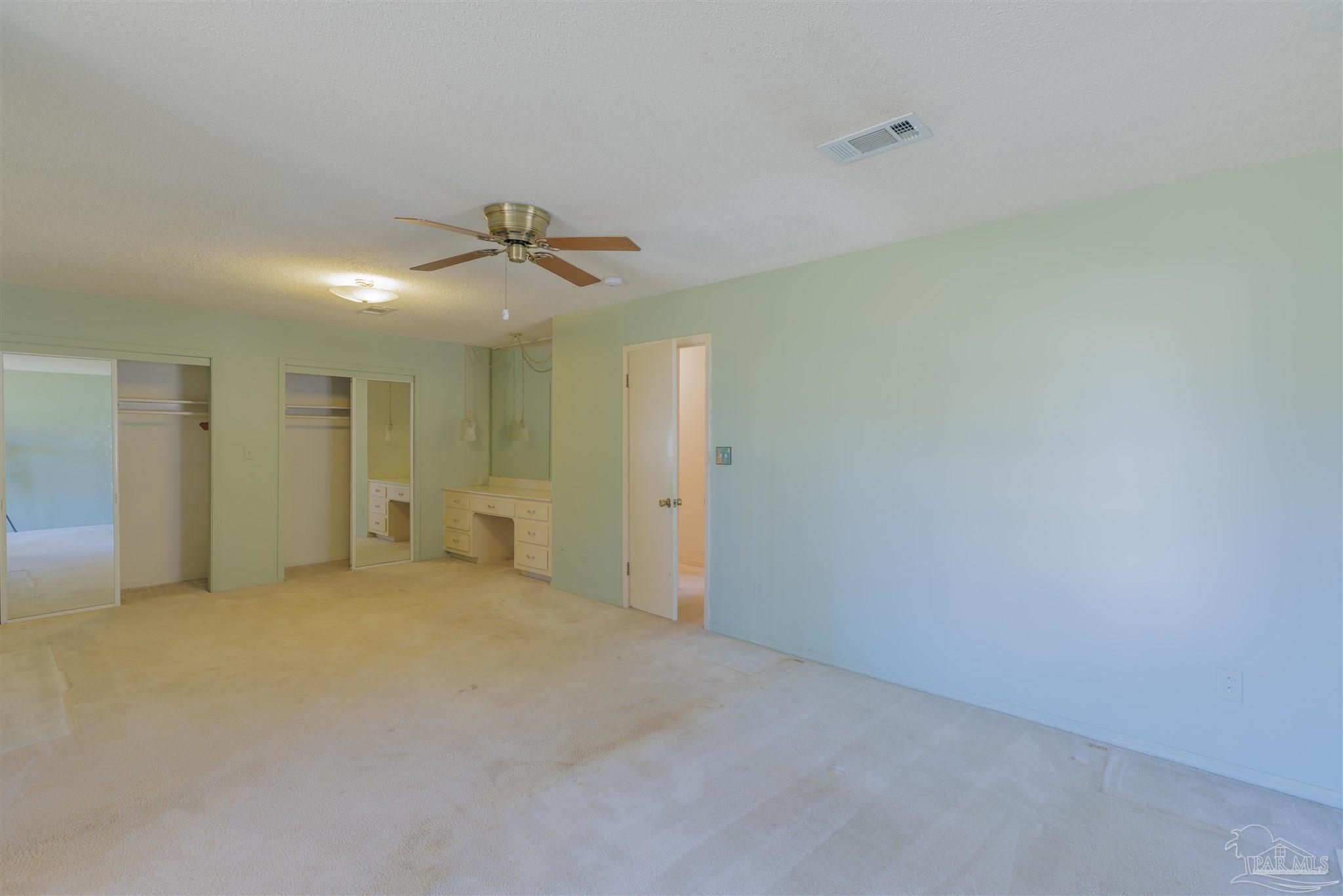5700 Adelyn Road Pensacola, FL 32504 - Photo 24 of 33 an empty room with a ceiling fan and a window