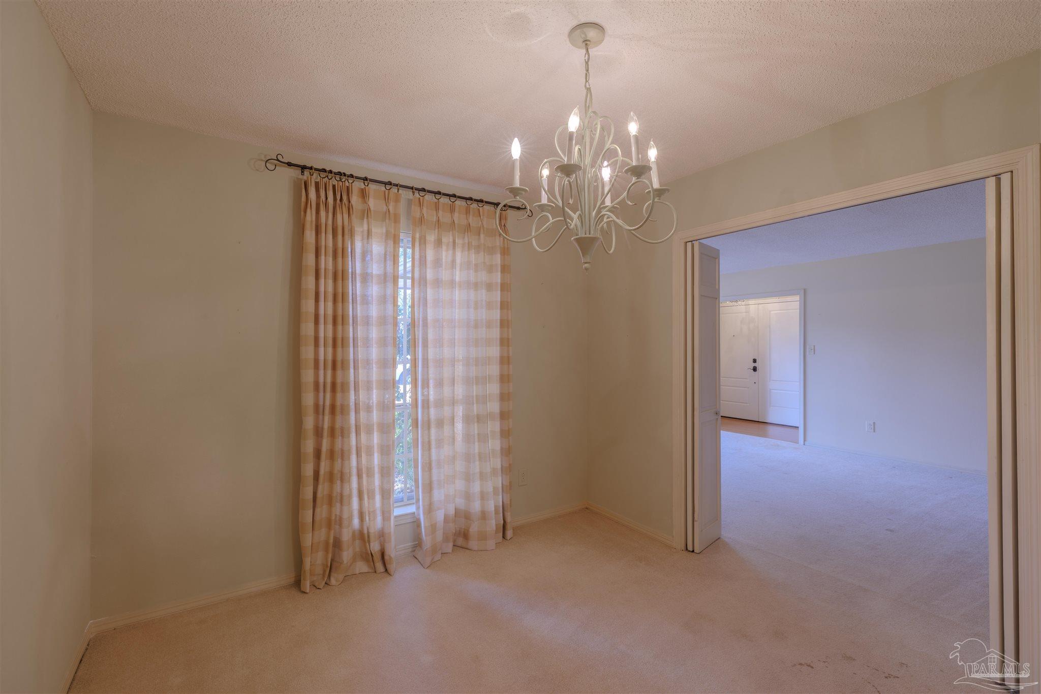 5700 Adelyn Road Pensacola, FL 32504 - Photo 6 of 33 a view of a chandelier in big room and chandelier