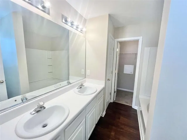 a bathroom with a double vanity sink and mirror