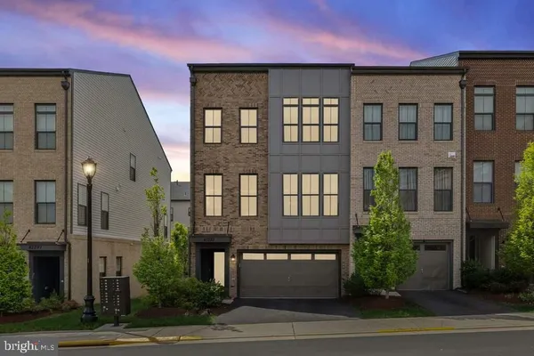 a view of a brick building next to a yard