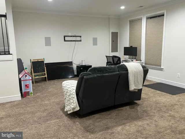a living room with furniture a flat screen tv and a closet