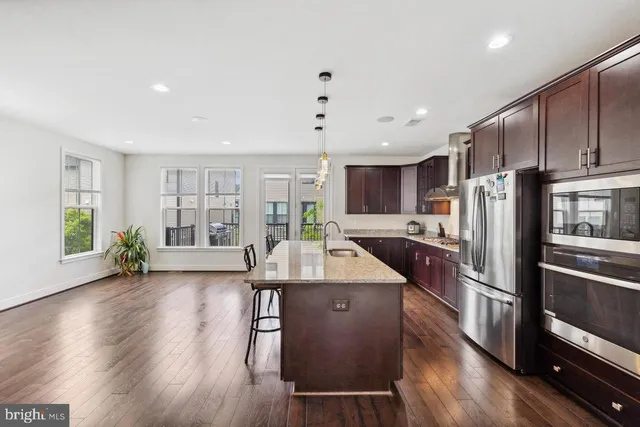 a kitchen with counter top space a sink appliances and cabinets