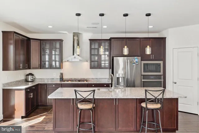 a kitchen with stainless steel appliances granite countertop a sink and refrigerator