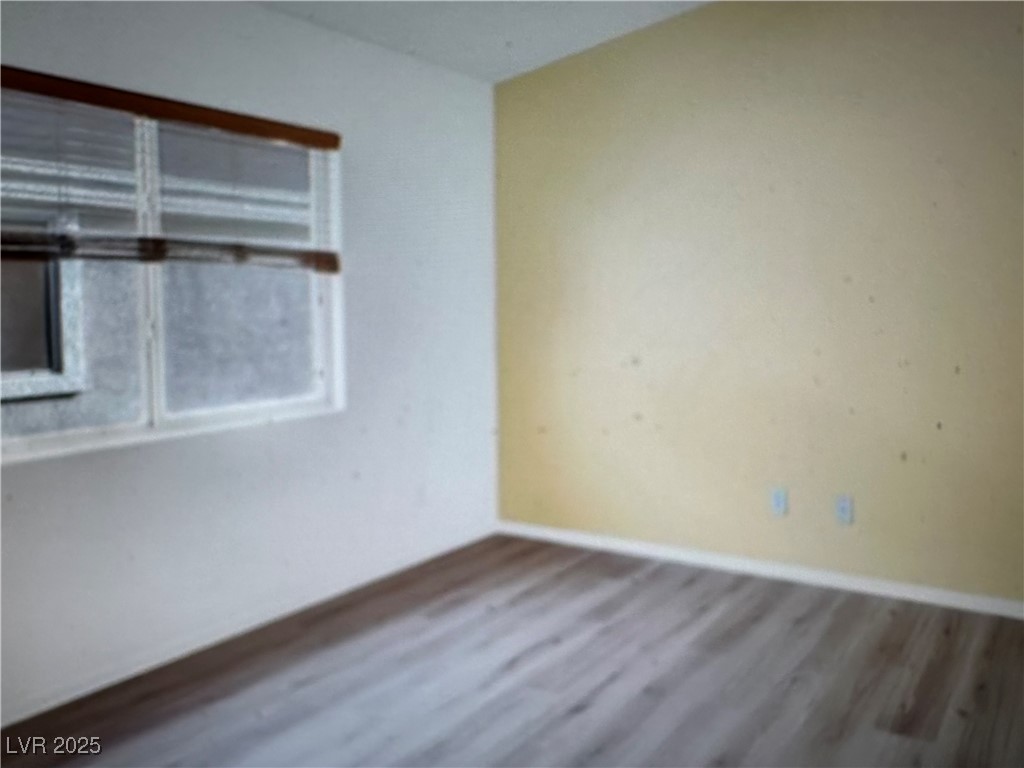 5512 East Jackpot Winner Lane, Unit 102 Las Vegas, NV 89122 - Photo 3 of 15 Spare room with wood finished floors and baseboards