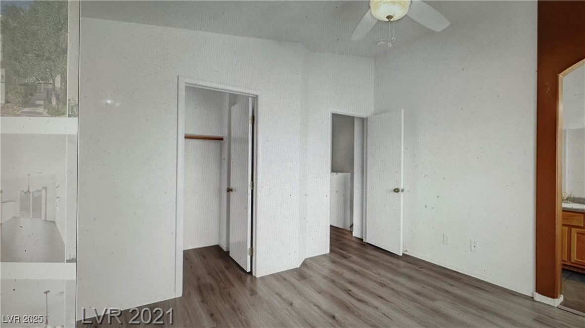5512 East Jackpot Winner Lane, Unit 102 Las Vegas, NV 89122 - Photo 6 of 15 Unfurnished bedroom with wood finished floors, connected bathroom, and a closet