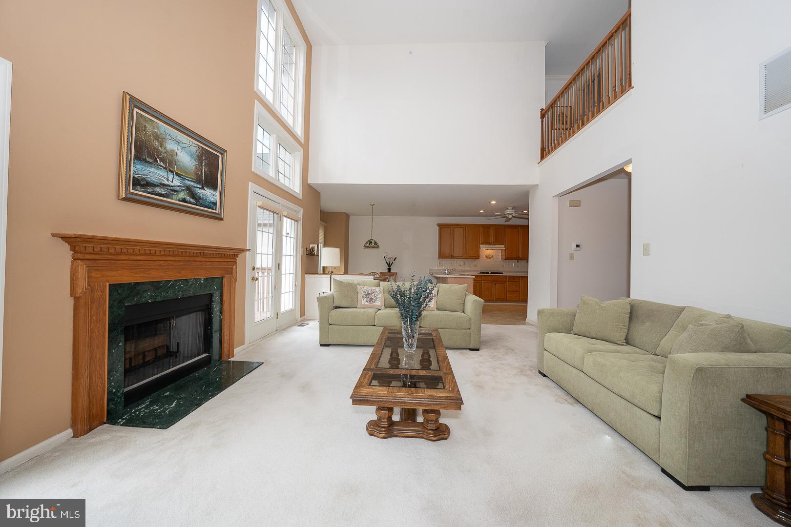 28 Ridgeview Road Newtown Square, PA 19073 - Photo 13 of 49 a living room with furniture a fireplace and a large mirror next to a window