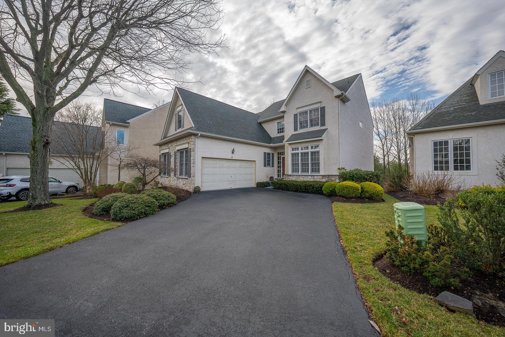28 Ridgeview Road Newtown Square, PA 19073 - Photo 3 of 49 a front view of a house with a garden and trees