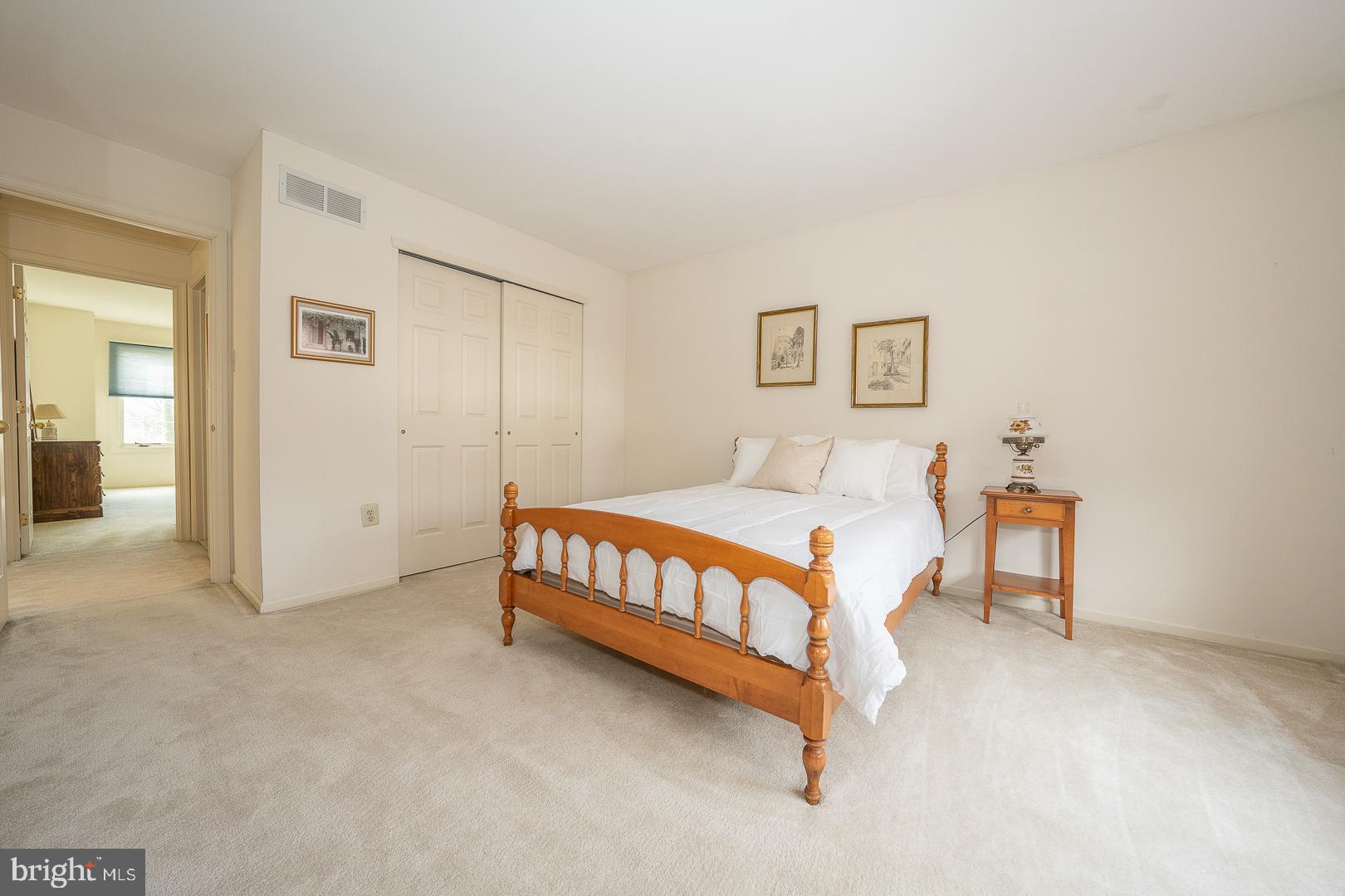 28 Ridgeview Road Newtown Square, PA 19073 - Photo 36 of 49 a bedroom with a bed and a lamp