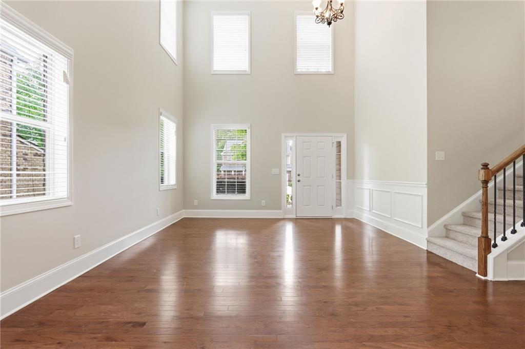 1515 Riva Ridge Suwanee, GA 30024 - Photo 5 of 35 an empty room with wooden floor and windows