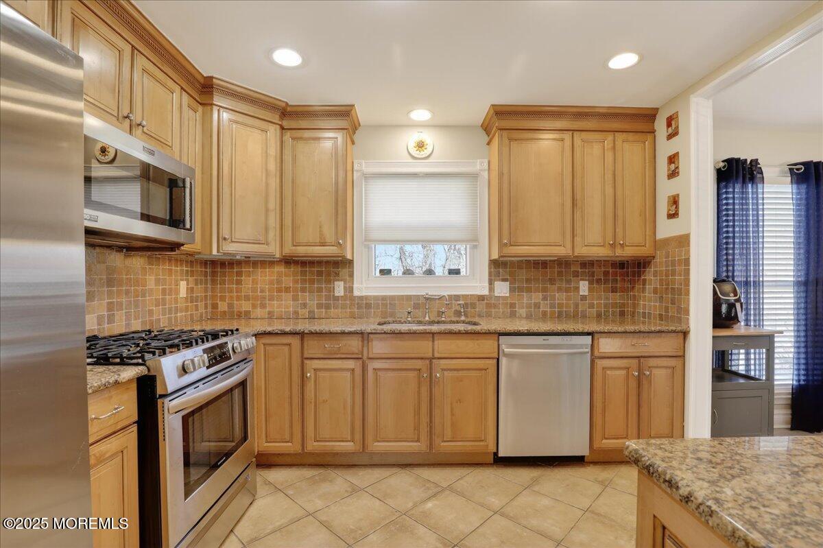 53 Sweet Gum Road Howell, NJ 07731 - Photo 14 of 62 a kitchen with stainless steel appliances granite countertop a stove a sink and a microwave