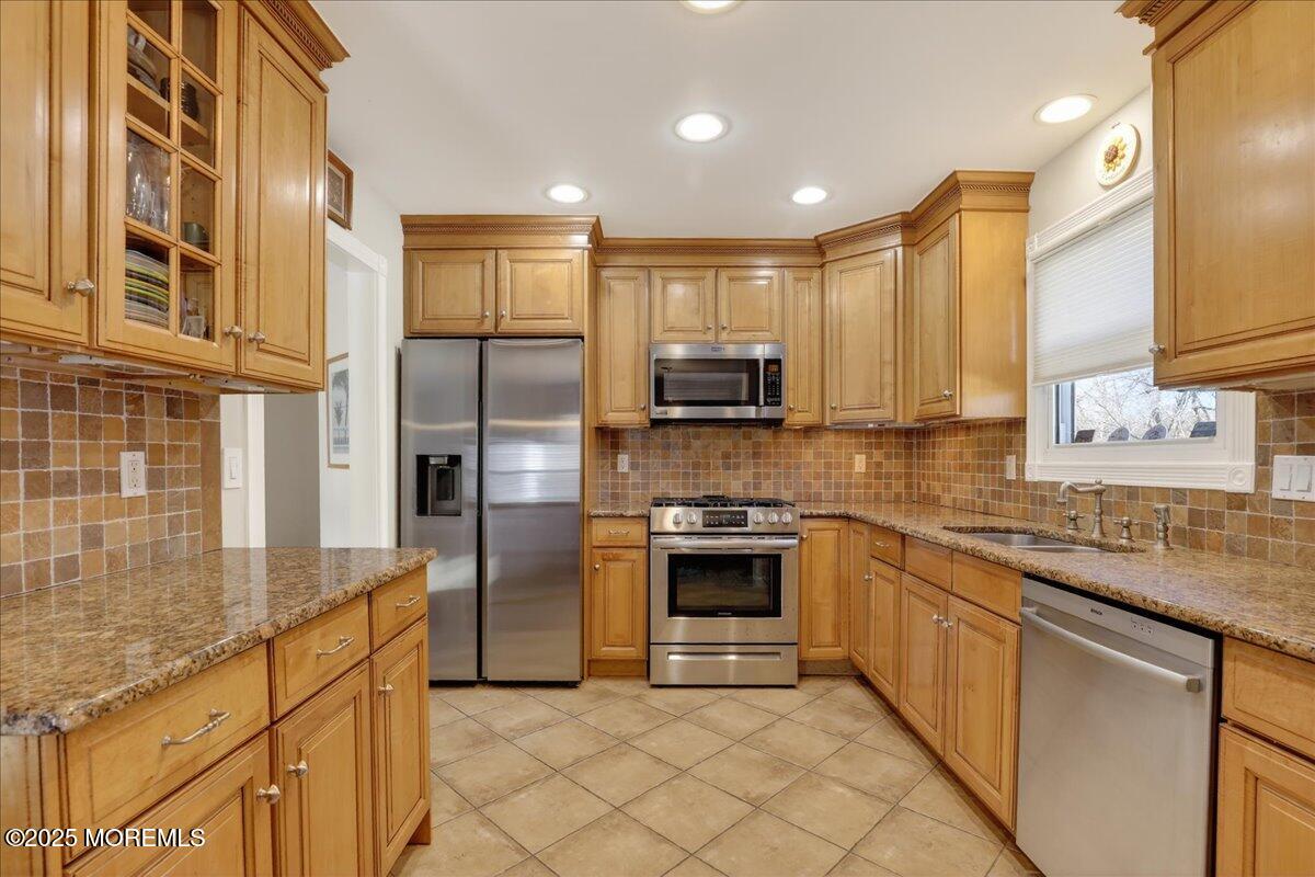 53 Sweet Gum Road Howell, NJ 07731 - Photo 17 of 62 a large kitchen with stainless steel appliances granite countertop a stove a sink and a microwave
