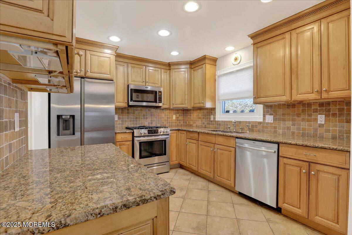 53 Sweet Gum Road Howell, NJ 07731 - Photo 19 of 62 a kitchen with stainless steel appliances granite countertop a stove a sink and a microwave