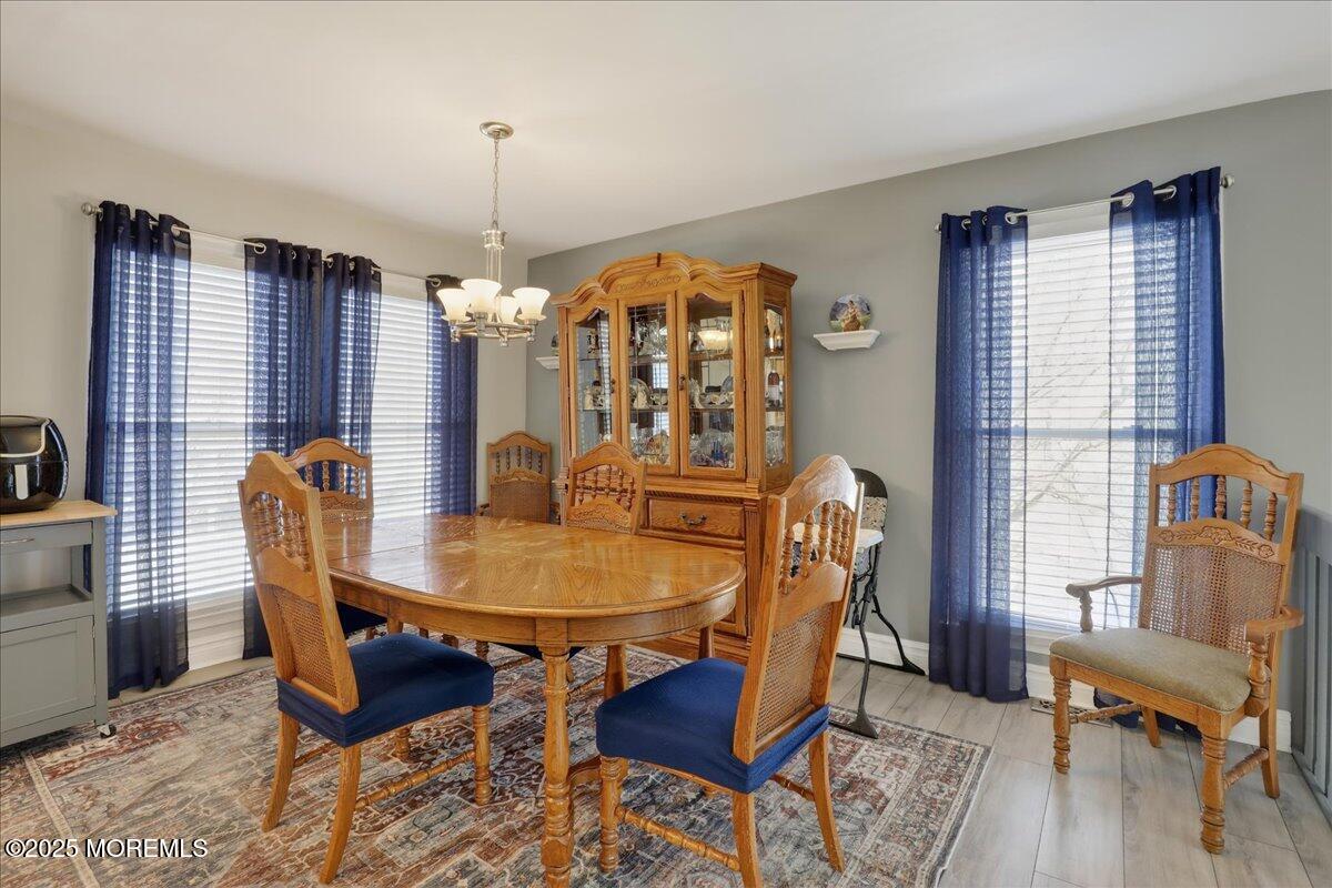 53 Sweet Gum Road Howell, NJ 07731 - Photo 20 of 62 a dining room with furniture a chandelier and wooden floor