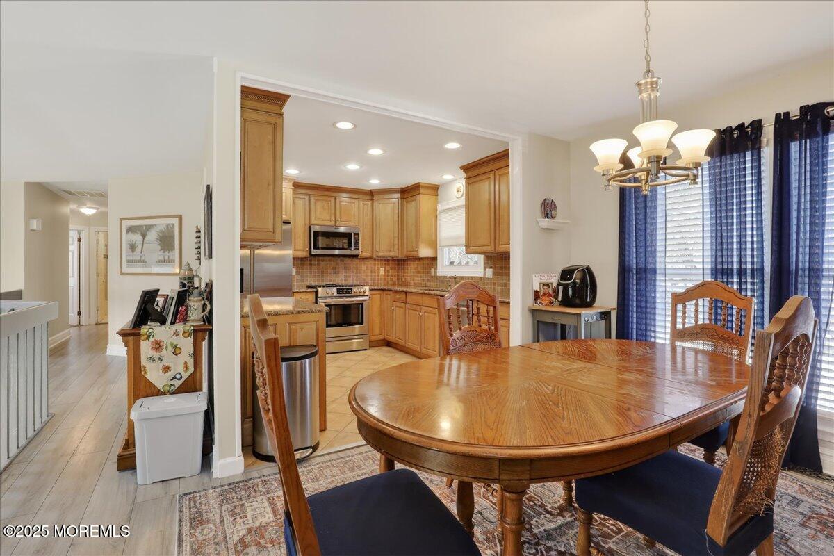 53 Sweet Gum Road Howell, NJ 07731 - Photo 22 of 62 a dining room filled chandelier and wooden floor
