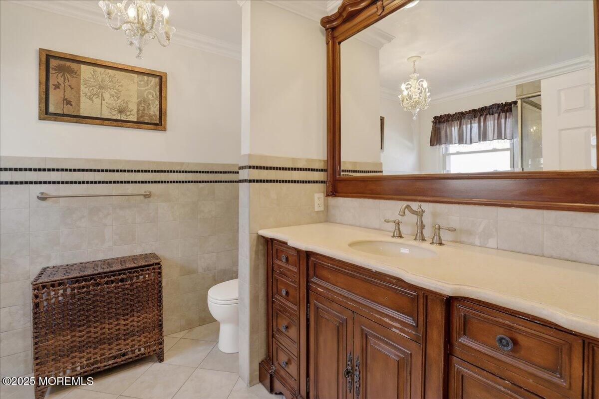 53 Sweet Gum Road Howell, NJ 07731 - Photo 27 of 62 a bathroom with a sink a toilet a mirror and shower