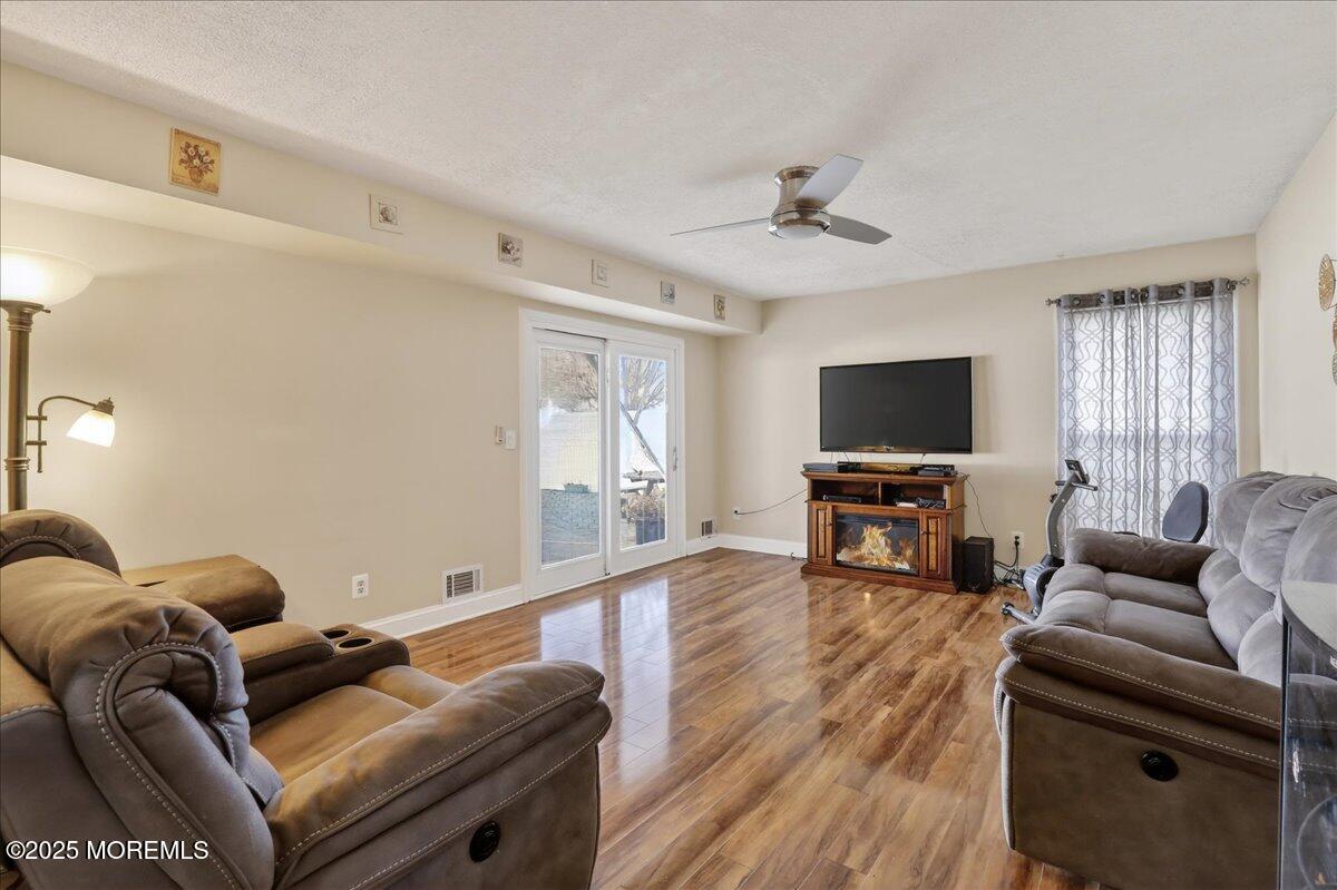 53 Sweet Gum Road Howell, NJ 07731 - Photo 34 of 62 a living room with furniture and a flat screen tv