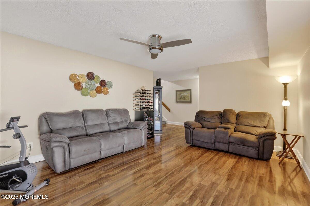 53 Sweet Gum Road Howell, NJ 07731 - Photo 35 of 62 a living room with furniture and a wooden floor