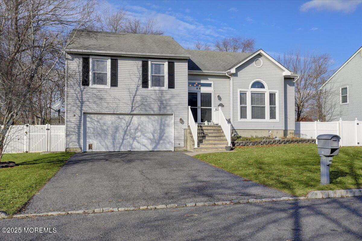 53 Sweet Gum Road Howell, NJ 07731 - Photo 57 of 62 a front view of a house with a yard and garage