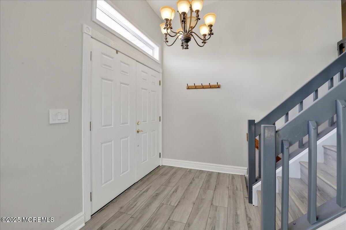 53 Sweet Gum Road Howell, NJ 07731 - Photo 6 of 62 a view of a hallway with wooden floor and staircase