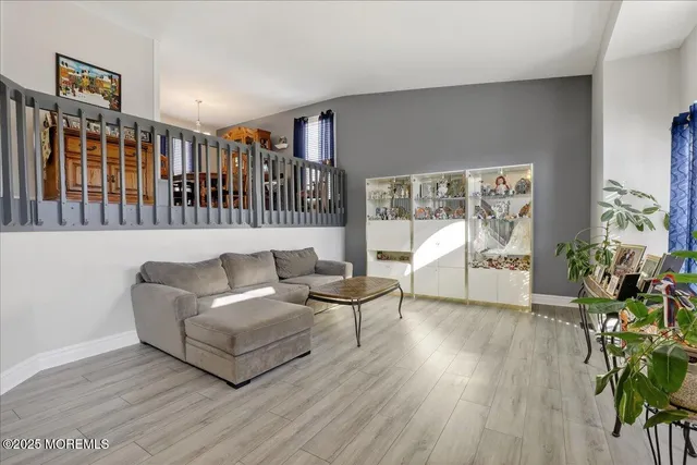a living room with furniture and a chandelier
