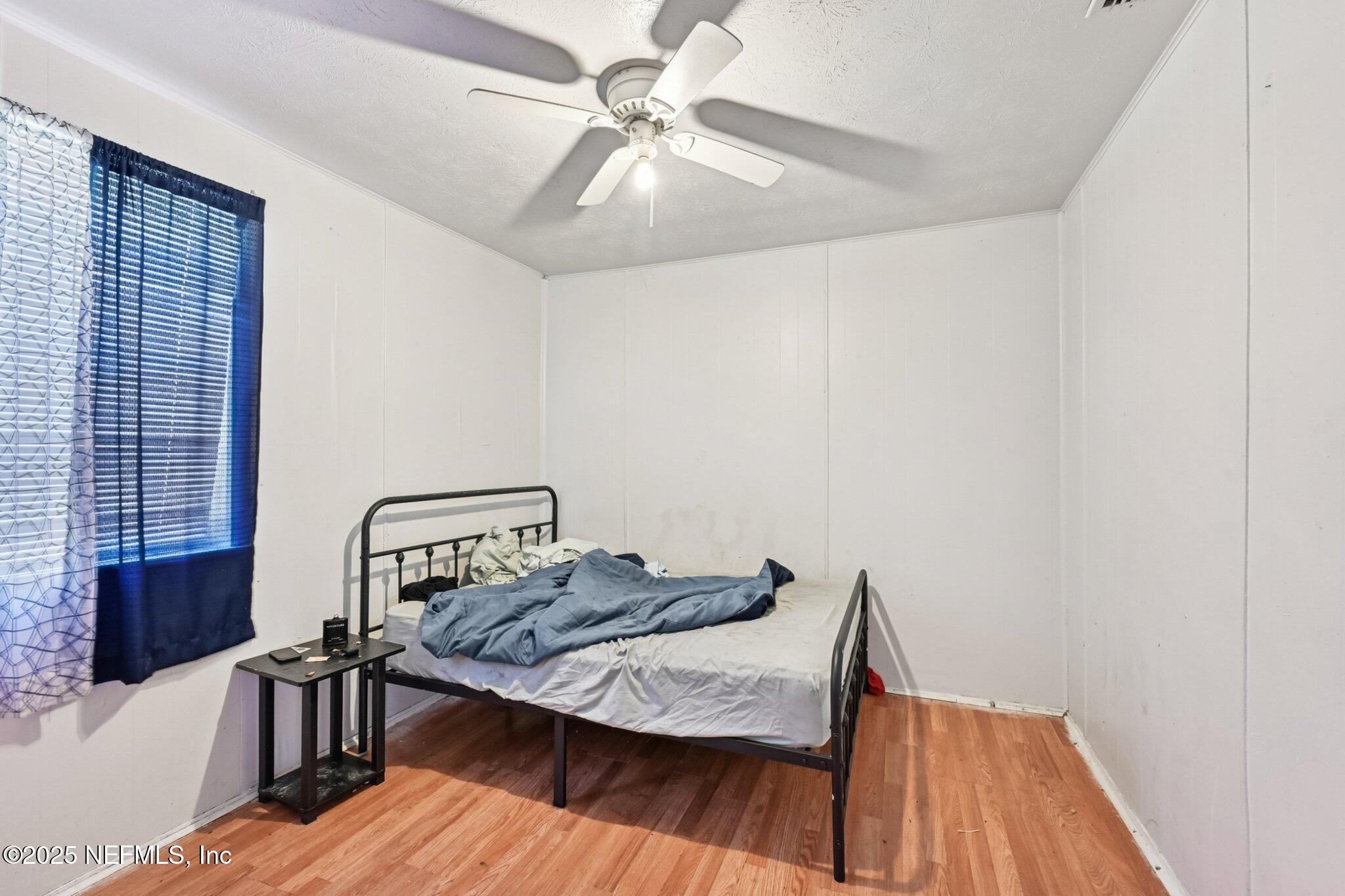 5635 Atlee Avenue Jacksonville, FL 32205 - Photo 14 of 31 a bedroom with a bed and wooden floor