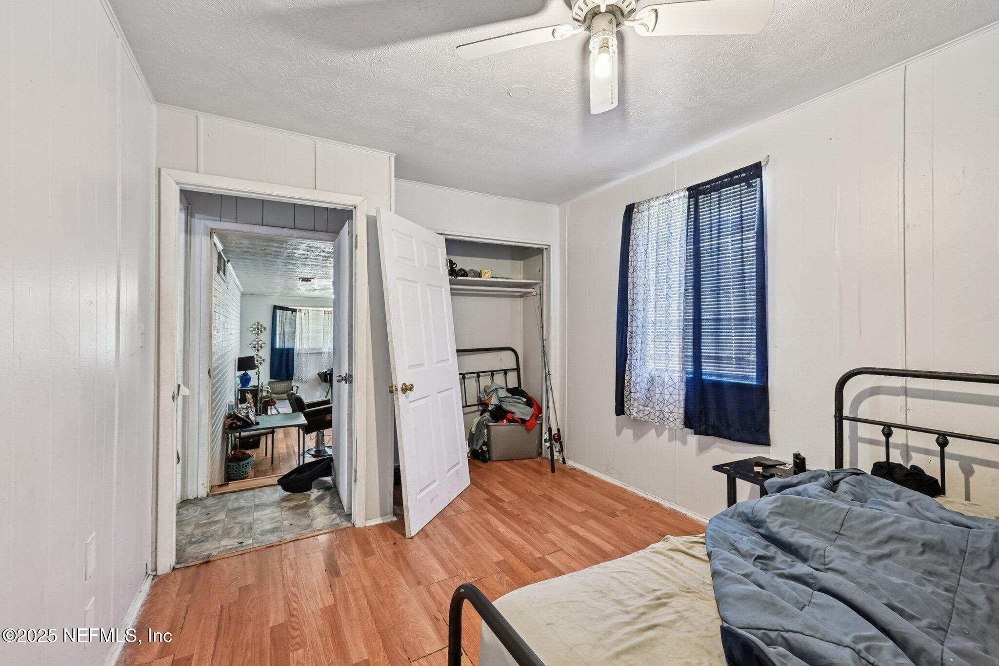 5635 Atlee Avenue Jacksonville, FL 32205 - Photo 15 of 31 a bed room with a bed and a mirror