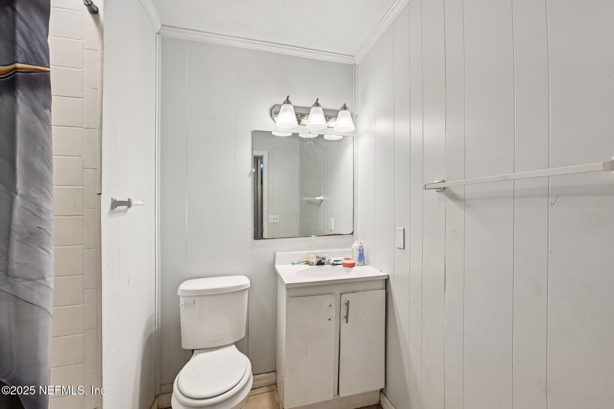 5635 Atlee Avenue Jacksonville, FL 32205 - Photo 16 of 31 a bathroom with a sink vanity mirror and toilet